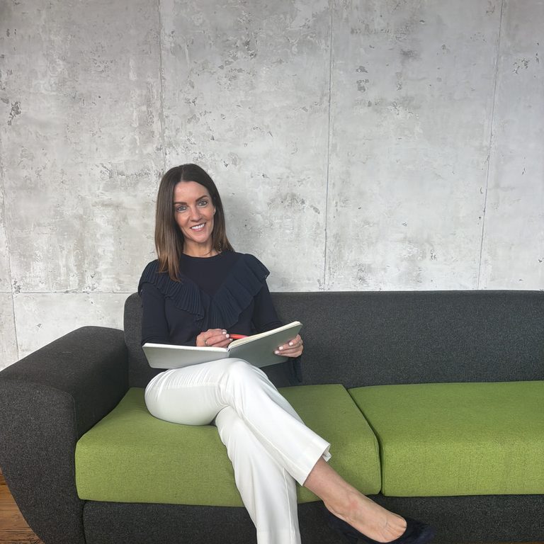 Chriselle Louise seated with a notebook, ready for a coaching session